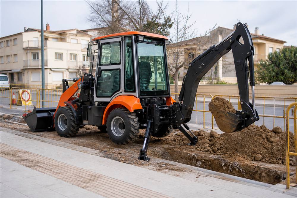 WZ25E electric backhoe loader at an urban utility repair site