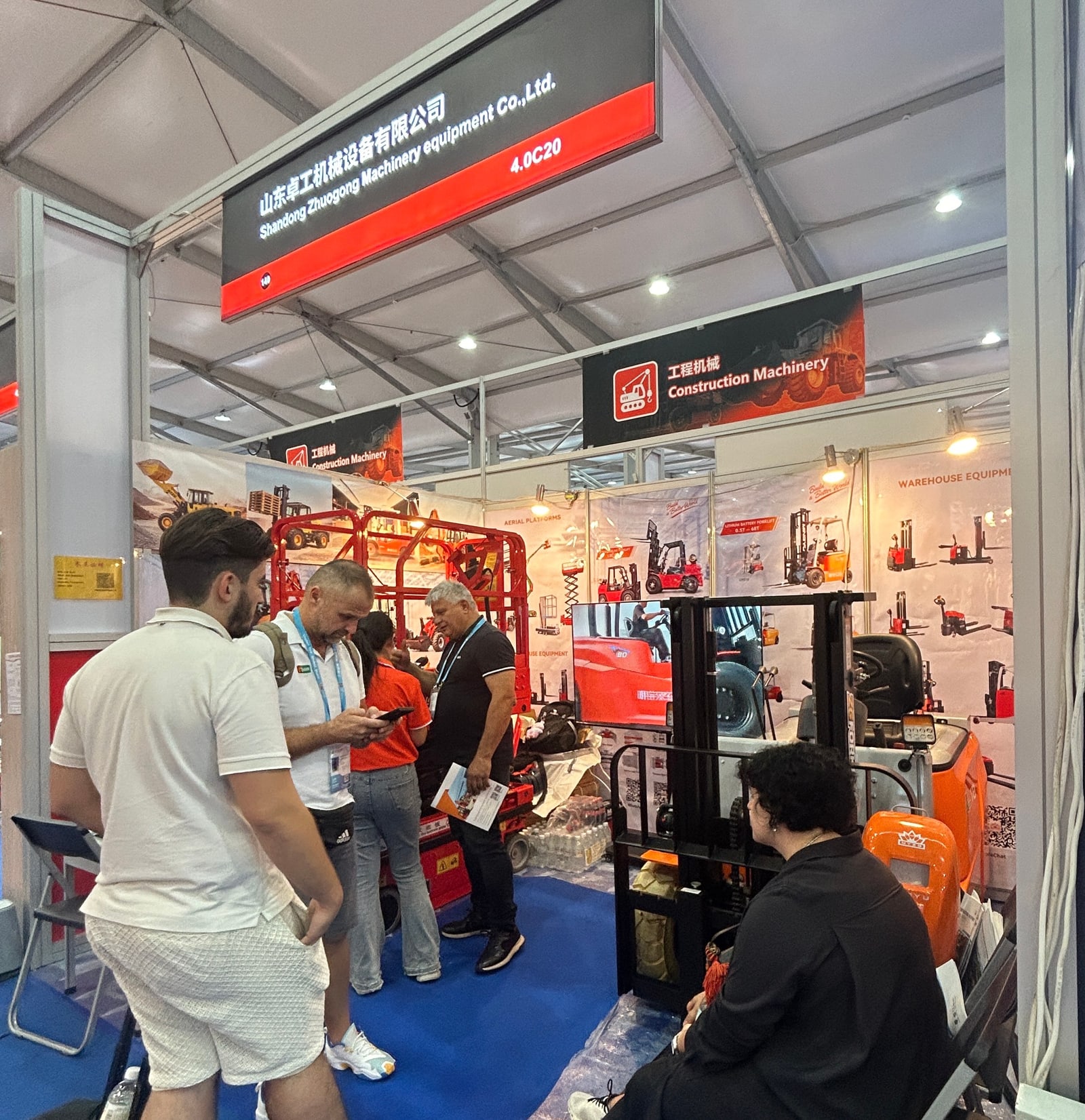 Visitors viewing equipment at booth 4.0C20