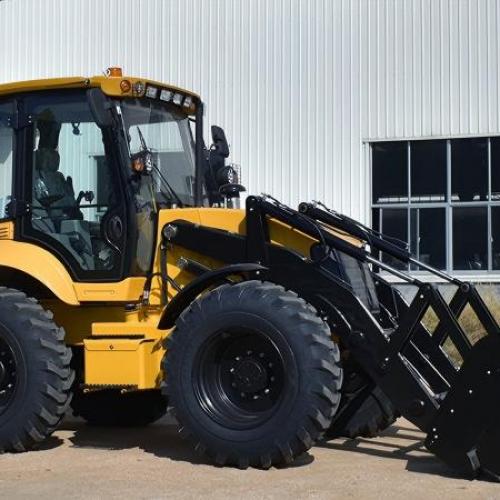 What attachments can be used on a backhoe loader?